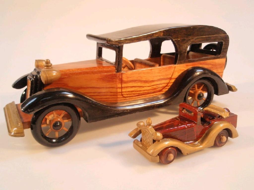 Appraisal: A wooden model Packard's style car and another smaller model