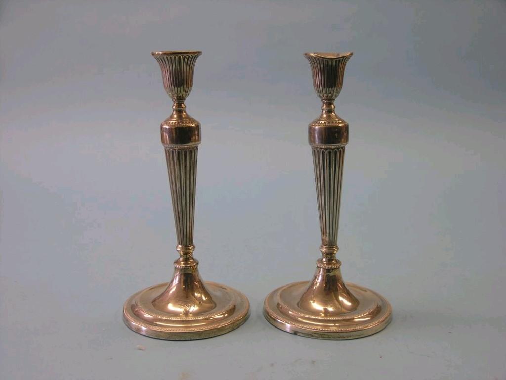 Appraisal: A pair of George III silver candlesticks fluted inverted bell-shape