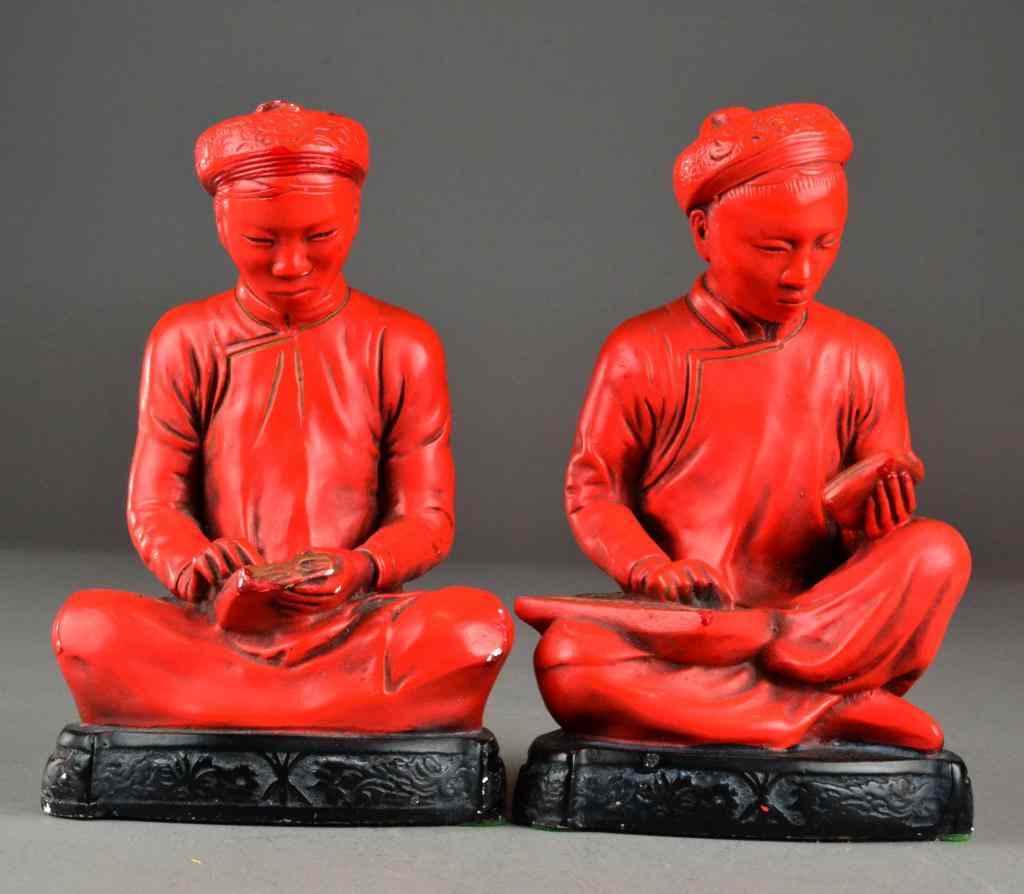 Appraisal: Pair Chinese Red Figural BookendsConsisting of matching painted plaster seated