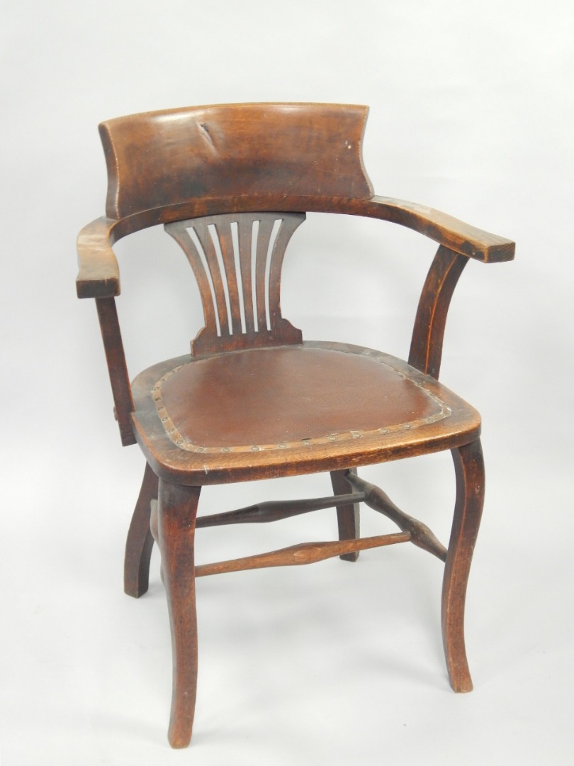 Appraisal: A late Victorian oak open arm office chair with American