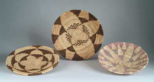 Appraisal: THREE SOUTHWEST INDIAN BASKETS All shallow bowls trays with geometric