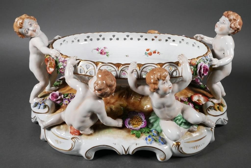 Appraisal: Large Porcelain dish surrounded by four putti or cherubs there