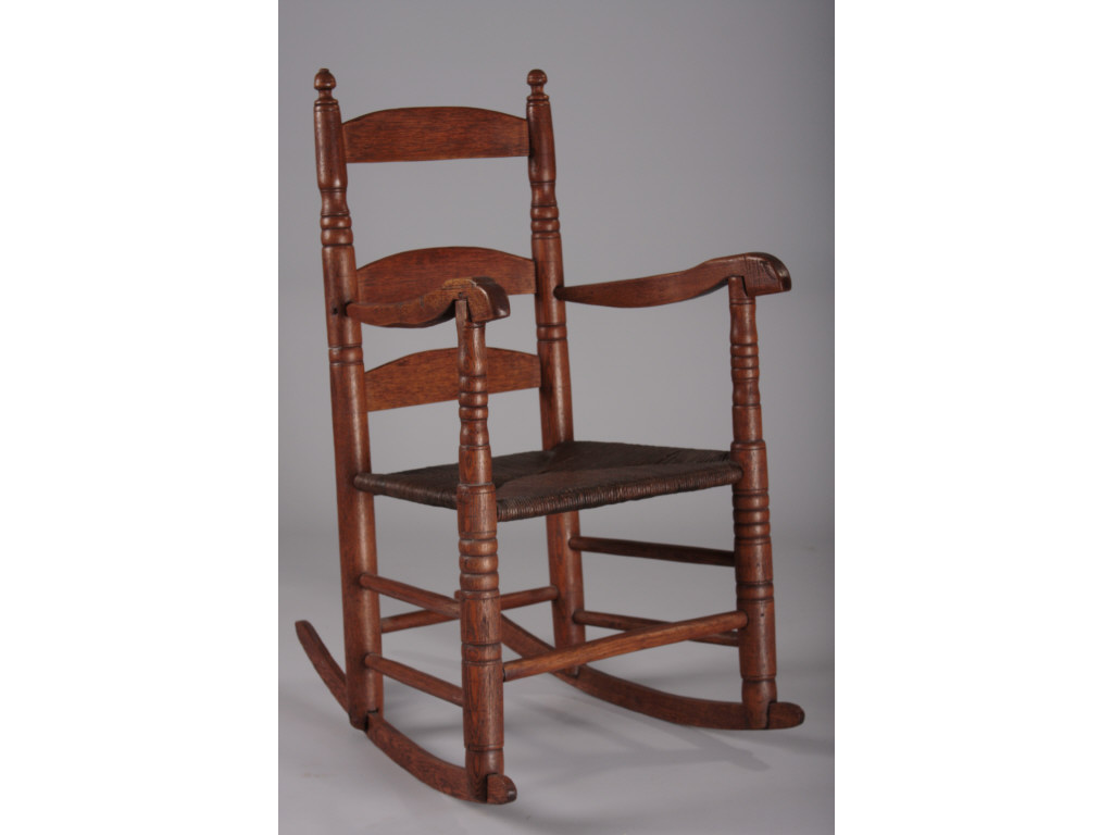 Appraisal: American Diminutive Rocking Chair Early th c mixed hardwoods finial