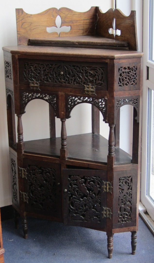 Appraisal: A Victorian oak corner display cabinet with fretwork and blind