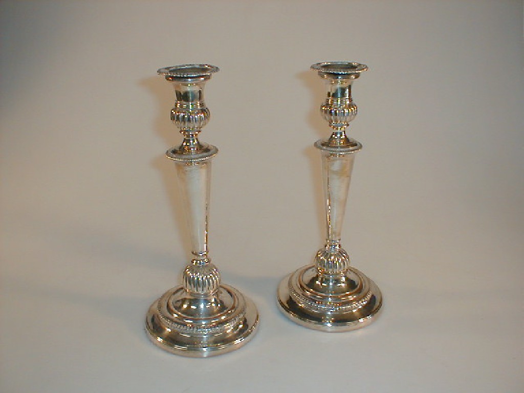 Appraisal: A pair of electroplate on copper candlesticks with gadrooned sconces