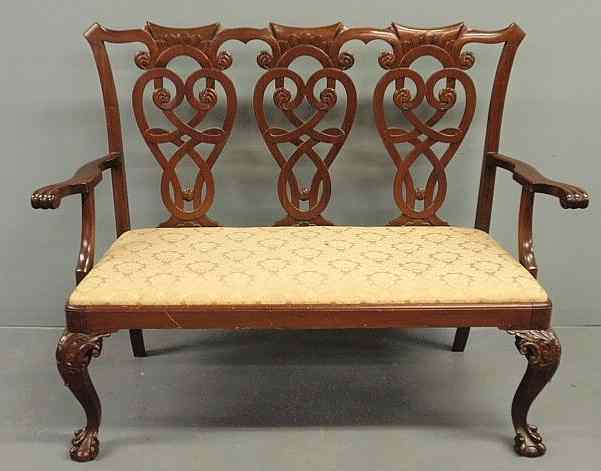 Appraisal: Chippendale style mahogany settee with carved splat slip seat and