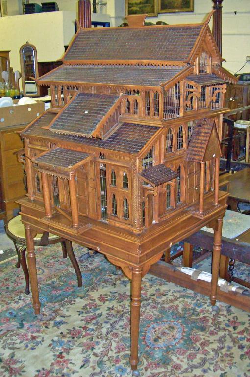 Appraisal: A large carved hardwood bird cage in the form of