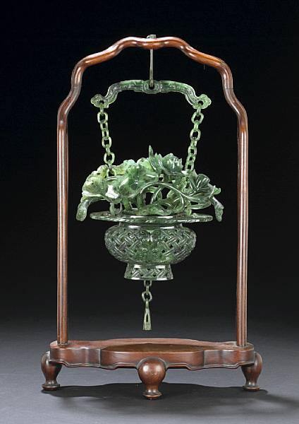 Appraisal: A 'spinach' jade hanging vase Finely carved in openwork and