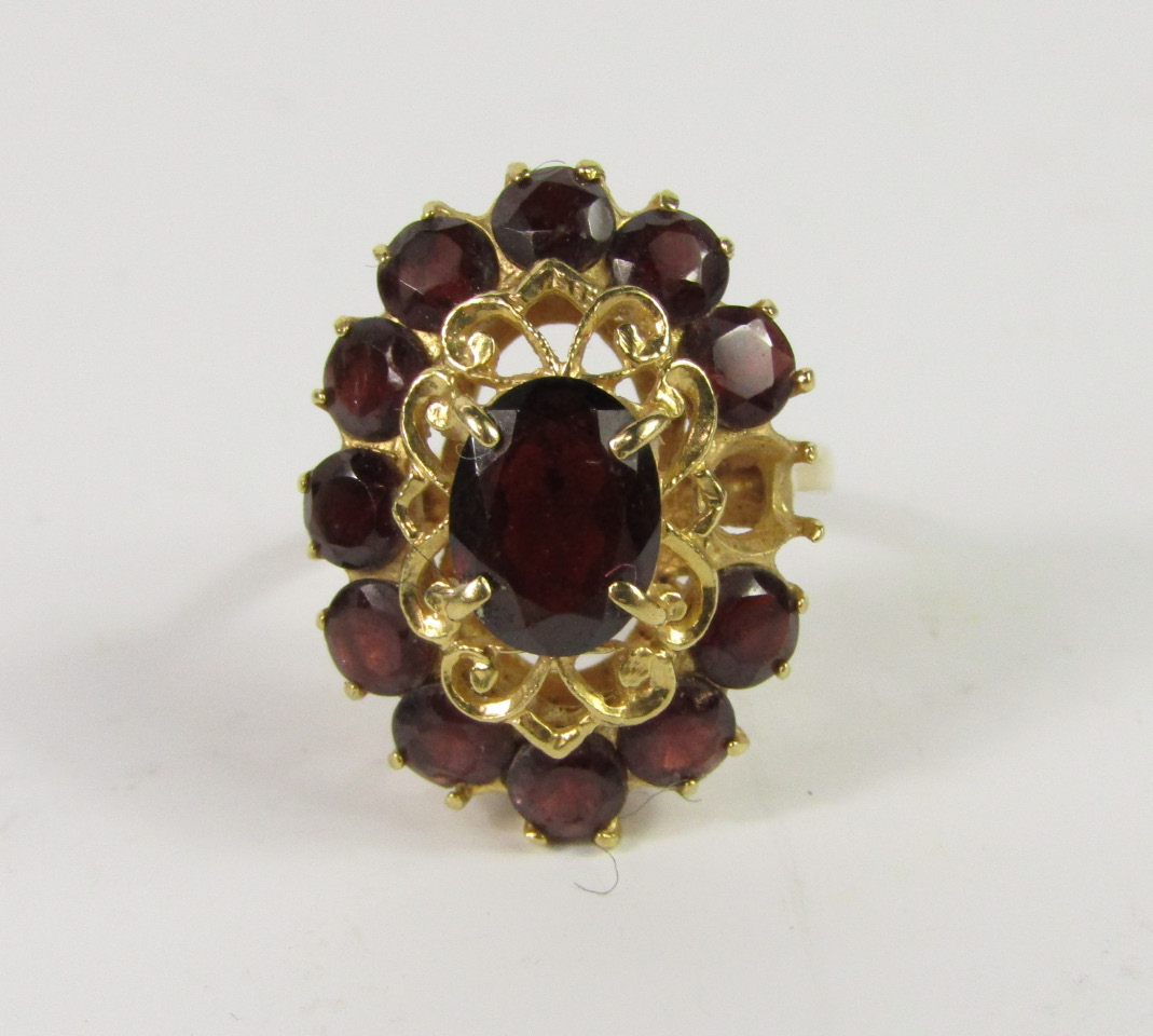 Appraisal: A garnet set oval cluster ring yellow metal marked ct