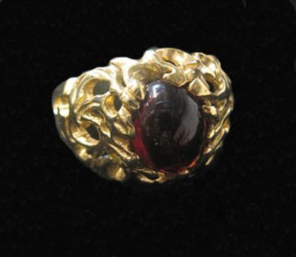 Appraisal: karat yellow gold and garnet ring Oval cabochon garnet in