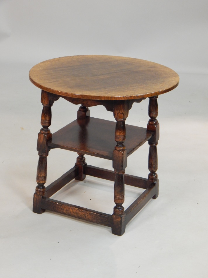 Appraisal: A Titchmarsh Goodwin oak two tier table the circular top