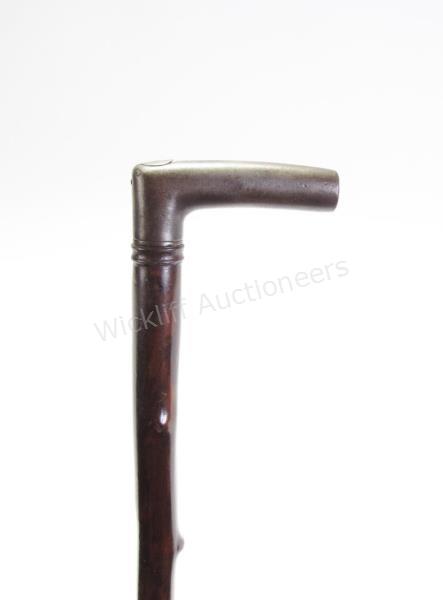 Appraisal: French Flicker Cane natural solid branch shaft metal handle with