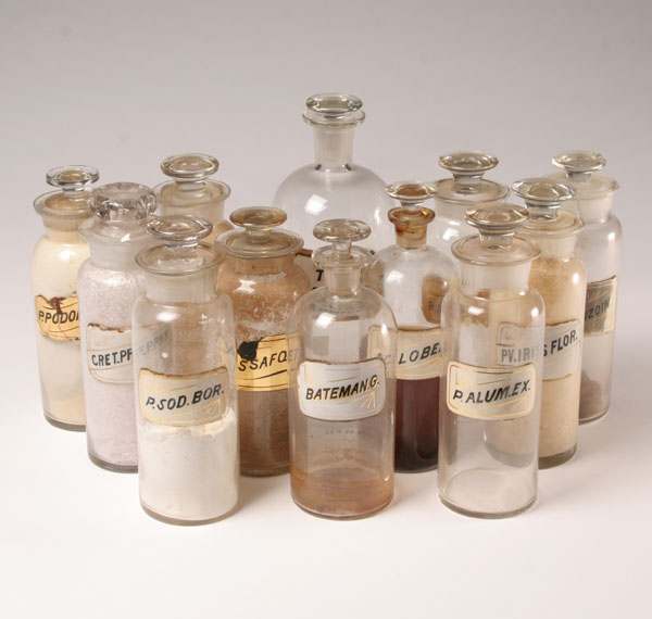 Appraisal: Twelve stoppered pharmacy bottles with glass labels Tallest H Minor