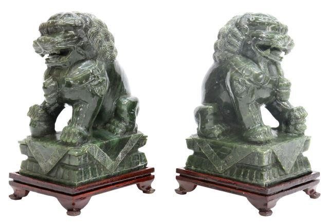 Appraisal: pair Chinese carved green hardstone foo lions seated on integral