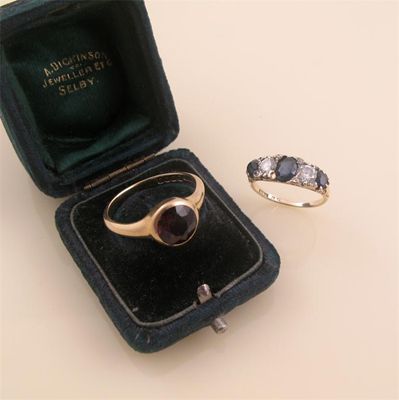 Appraisal: A diamond and sapphire half hoop ring set with three