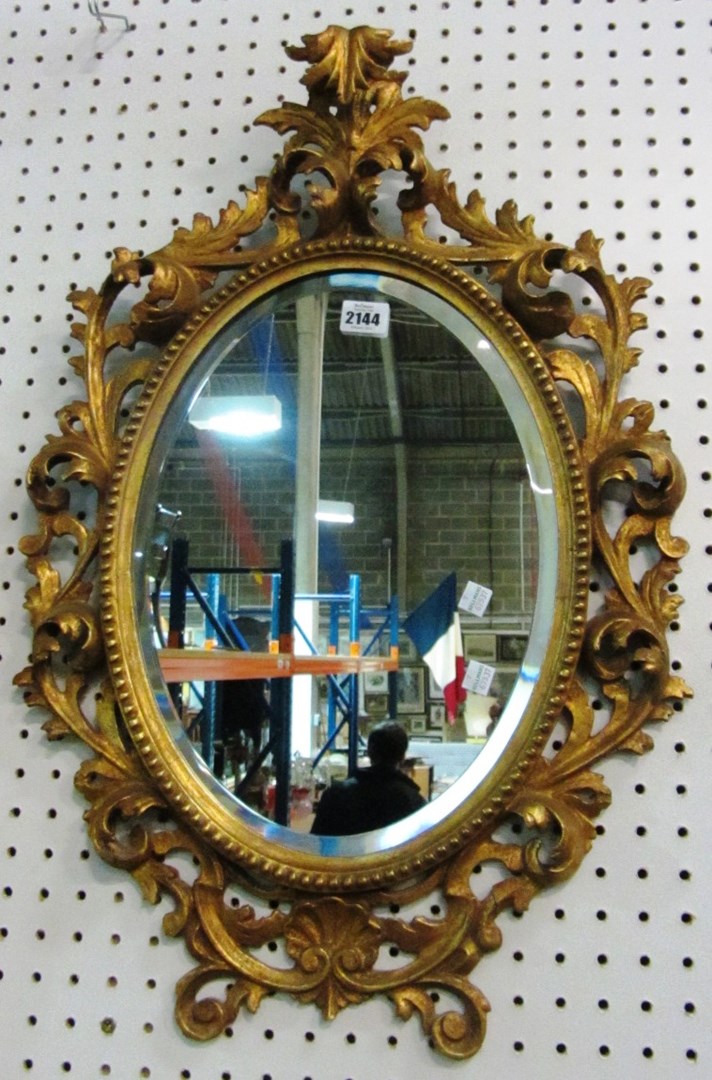 Appraisal: An oval Florentine style mirror