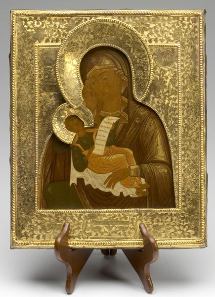 Appraisal: RUSSIAN ICON Gilded Mother of God with brass cover and