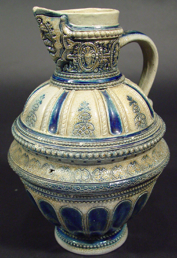 Appraisal: German stoneware jug moulded with a mask to the spout