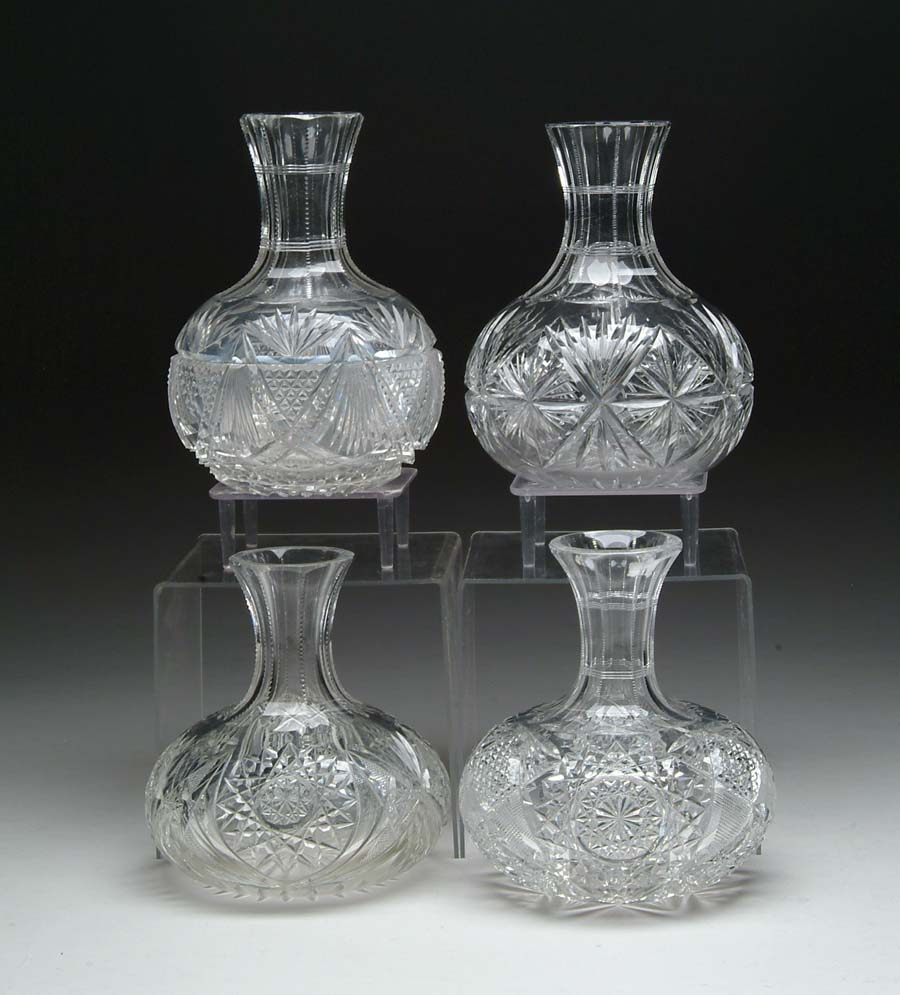 Appraisal: FOUR CUT GLASS WATER CARAFES Sunburst and fan pattern SIZE