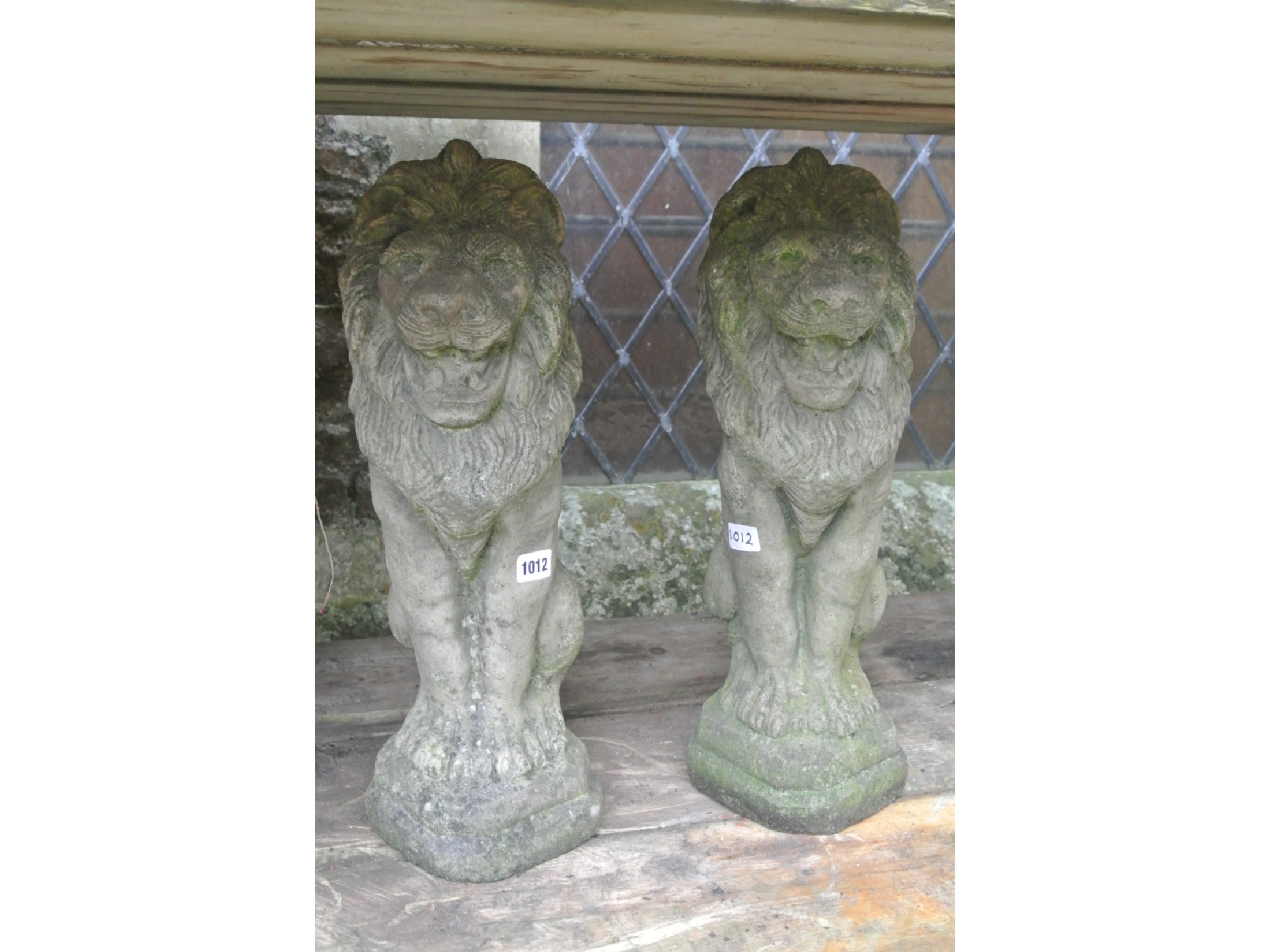 Appraisal: A pair of weathered cast composition stone garden ornaments in