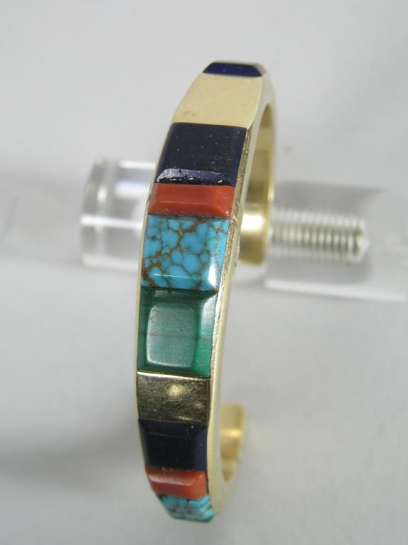 Appraisal: A Continental Bangle signed 'SAUNSA' inlaid faceted plaques of malachite