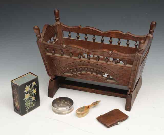 Appraisal: AN AUSTRIAN MINIATURE WALNUT COT with turned finials and on