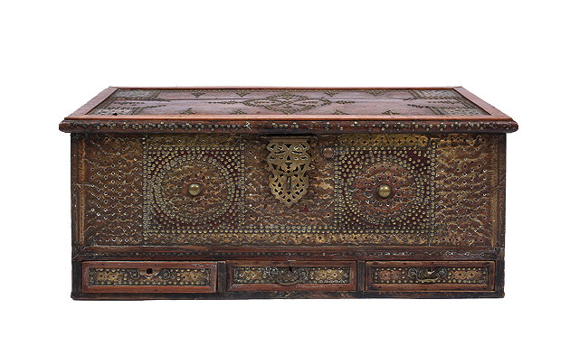 Appraisal: A HARDWOOD STUDDED ZANZIBAR MULE CHEST with pierced metalwork and