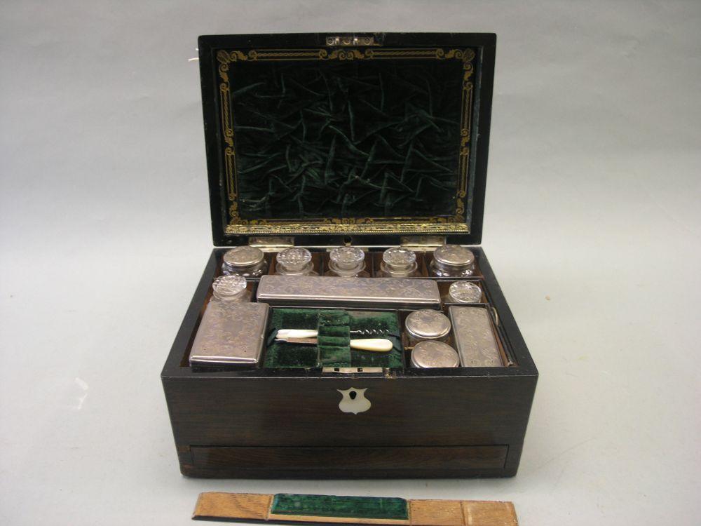 Appraisal: A Victorian rosewood vanity case enclosed fittings with engraved plated