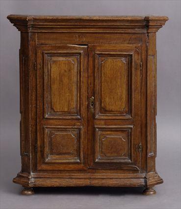 Appraisal: FRENCH PROVINCIAL MINIATURE OAK ARMOIRE The overhang cornice with outset