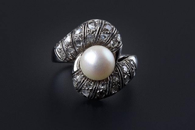 Appraisal: A cultured pearl and diamond dress ring of crossover design