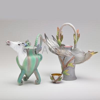 Appraisal: NANCY ADAMS Two carved porcelain teapot forms one of a