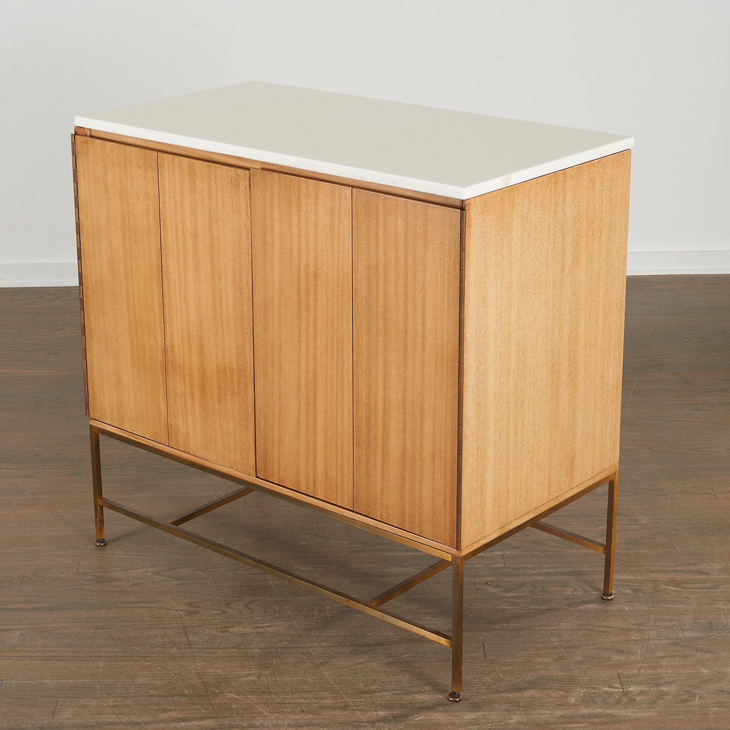 Appraisal: PAUL MCCOBB MAHOGANY AND BRASS CABINET c American with white