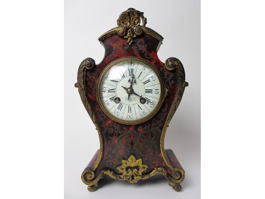 Appraisal: A French boulle style rococo scroll shaped mantel clock the