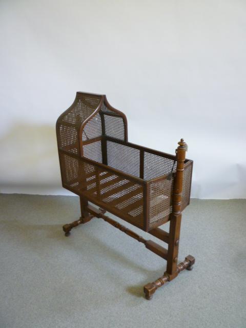 Appraisal: A MAHOGANY AND CANE WORK CRADLE early to mid th