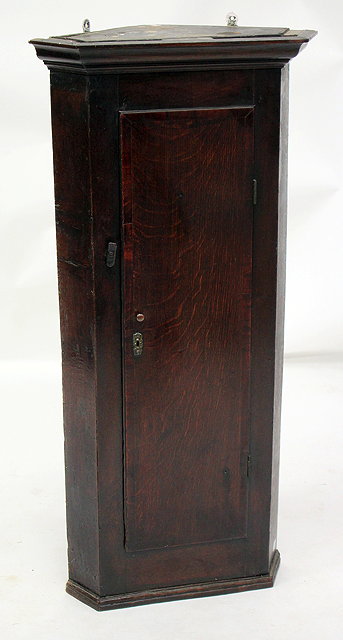 Appraisal: AN ANTIQUE OAK NARROW HANGING CORNER CUPBOARD the door with