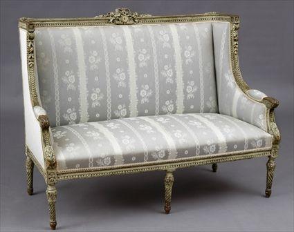 Appraisal: LOUIS XVI-STYLE CARVED GREY-PAINTED CANAPE A L'OREILLES The rectangular padded