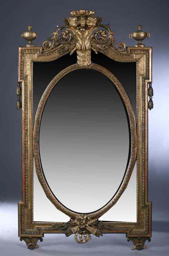 Appraisal: CONTINENTAL STYLE GILT-COMPOSITION WALL MIRROR Foliate carved crest flaked by