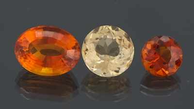 Appraisal: Three Unmounted Citrine Gemstones Oval faceted cut weighting ct Round