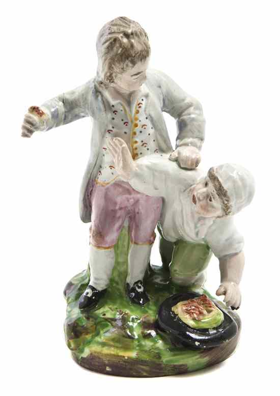 Appraisal: An English Pottery Figural Group depicting two children with birds