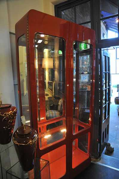 Appraisal: A 'S BURNT ORANGE GLAZE DISPLAY CABINET WITH MIRRORED BACK