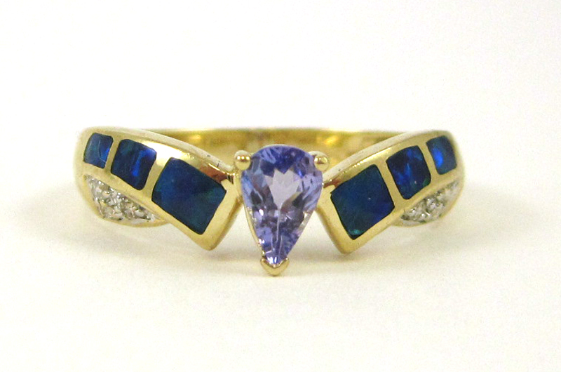 Appraisal: TANZANITE OPAL AND DIAMOND RING The k yellow gold ring