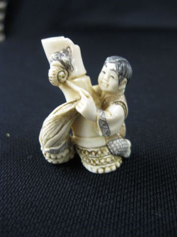 Appraisal: Carved Ivory Netsuke of a Seated Boy playing with a