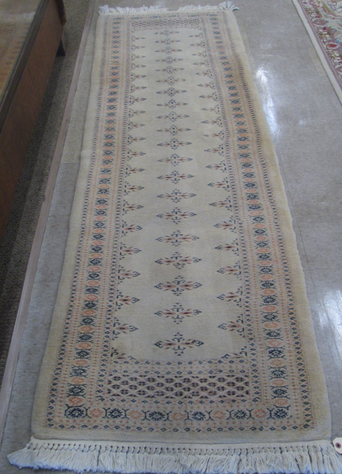 Appraisal: HAND KNOTTED BOKHARA RUNNER Indo-Bokhara light camel ground ' x