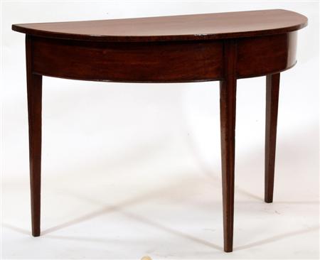 Appraisal: A George III mahogany demi lune table with cockbeaded frieze