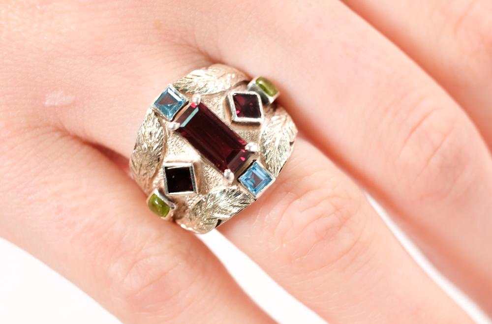 Appraisal: Sterling silver ring set with a rectangular x mm Garnet