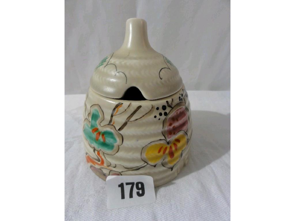 Appraisal: A Clarice Cliff honey pot and cover in the form