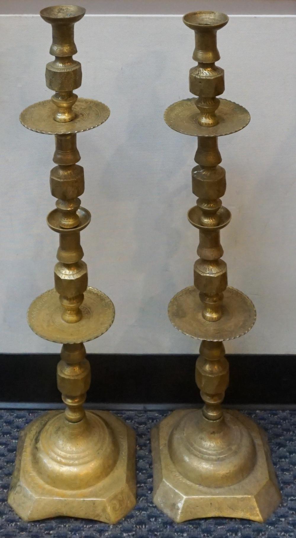 Appraisal: PAIR INDO-PERSIAN CHASED BRASS TORCHIERE CANDLESTICKS H IN CM Pair