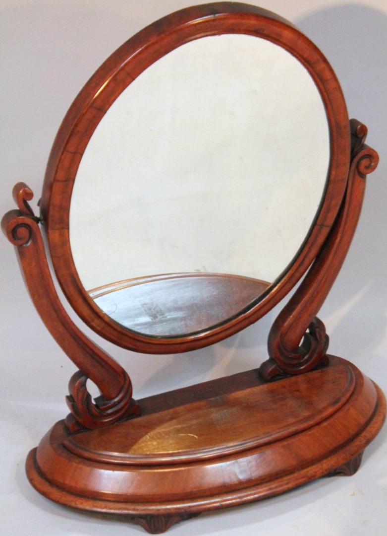 Appraisal: A Victorian mahogany table mirror the oval shaped glass flanked