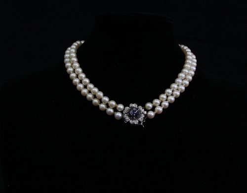 Appraisal: A two-row cultured pearl necklace with a sapphire and diamond