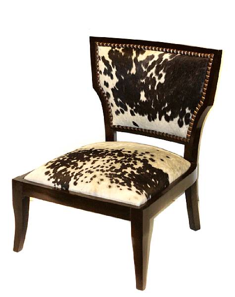 Appraisal: A pair of modern ebonized chairs with cow hide upholstery